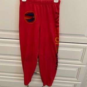 Red AV Nation sweatpants.